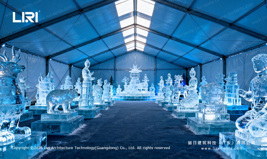 Illuminated ice sculptures displayed inside an event tent